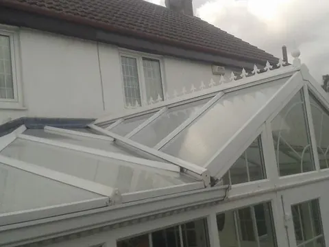 A white conservatory roof after cleaning, the glass clear again.