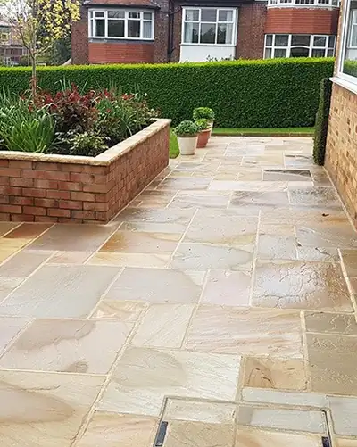 After: the same patio clean, the sandstone colour back.